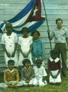 Group of children holding a Cuban flag
